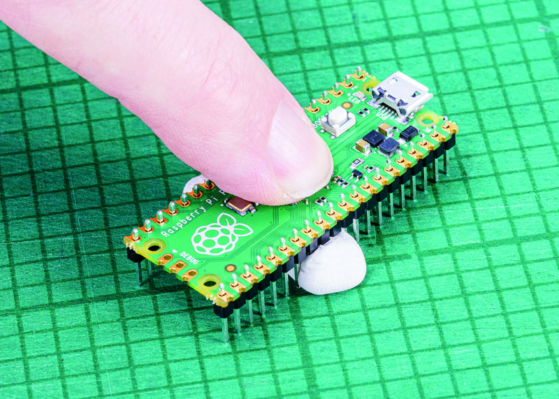 Figure 1-9: You can hold the headers in place with sticky putty before soldering
